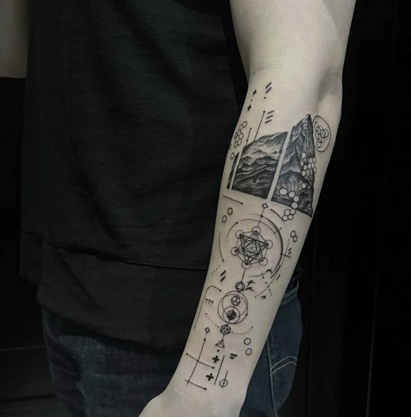 Completed tattoo on the forearm: shaded mountain panels above interlocking circles, hexagons and fine geometric lines in black and grey